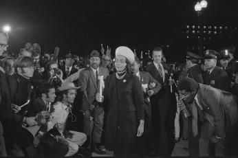 Coretta Scott King holding a candle and leading a march at night to the White House as part of the Moratorium to End the War in Vietnam
