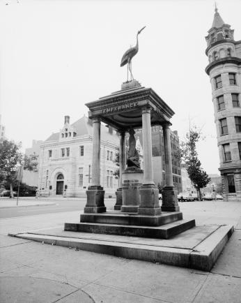 Black and white photo of statue with four pillars and a roof inscribed with "Temperance" on it.