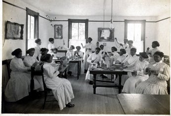 a vocational classroom with students doing various domestic tasks