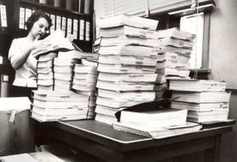 Chemist Lee Geismar, who was part of the team that reviewed the new drug application for thalidomide in the early 1960s, is shown some years later poring over several volumes of another application