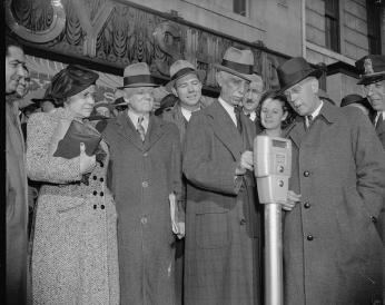 D.C.'s first parking meter. (Source: Library of Congress) Commissioner Melvin Hazen and William Van Duzer, putting the first nickel in the parking meters ordered by Congress for a test in Washington in November 1938.