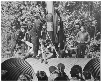 "Demonstrators protesting construction of the Three Sisters Bridge are removed by police from atop huge culvert sections" October 1969