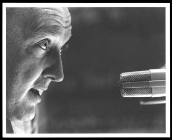 An up close shot of Grant talking into a microphone (1960). An up close shot of Grant talking into a microphone (1960).