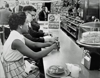 Activists at drug store counter in Arlington. (Source: Washington Area Spark on Flickr.)