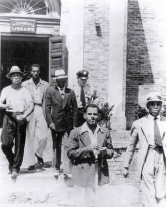 Police removing sit-in participants from the Alexandria Library (Source: Wiikpedia)