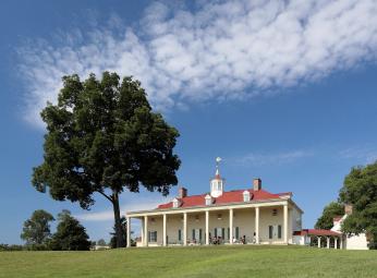 A picture of Mount Vernon from the perspective of the Potomac. A green lawn is seen in the foreground. The mansion is in the background with the Piazza in full view. A picture of Mount Vernon from the perspective of the Potomac. A green lawn is seen in the foreground. The mansion is in the background with the Piazza in full view.