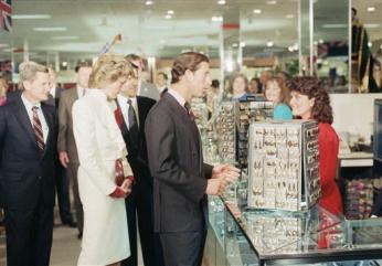 Prince Charles stops to chat with a sales clerk at a costume jewelry display in the Springfield, Va., J.C. Penny store on Nov. 11, 1985. Princess Diana looks at the jewelry. (AP Photo)