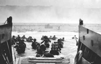 U.S. Soldiers disembark a landing craft at Normandy, France, June 6, 1944. By the end of the day some 150,000 Allied troops had landed on five Normandy beaches and three airborne drop zones. The invasion marked the beginning of the final phase of World War II in Europe, which ended with the surrender of Germany the following May. (Source: Wikimedia Commons, U.S. Department of Defense photo courtesy of the National Infantry Museum/Released) U.S. Soldiers disembark a landing craft at Normandy, France, June 6, 1944. By the end of the day some 150,000 Allied troops had landed on five Normandy beaches and three airborne drop zones. The invasion marked the beginning of the final phase of World War II in Europe, which ended with the surrender of Germany the following May. (Source: Wikimedia Commons, U.S. Department of Defense photo courtesy of the National Infantry Museum/Released)