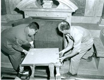 Two men placing the Declaration of Independence into the new display case at the National Archives (Source: National Archives)