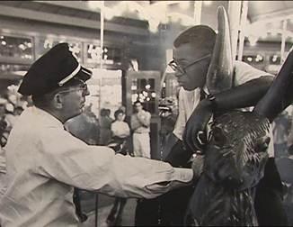 Officer Frank Collins confronts Laurence Henry on Glen Echo's Dentzel Carousel on June 30, 1960. (Photo source: National Park Service) Officer Frank Collins confronts Laurence Henry on Glen Echo's Dentzel Carousel on June 30, 1960. (Photo source: National Park Service)