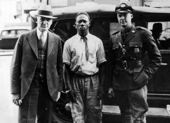 George Armwood transported to Baltimore by two police officers Two police officers transport prisoner George Armwood to Baltimore in the US state of Maryland.