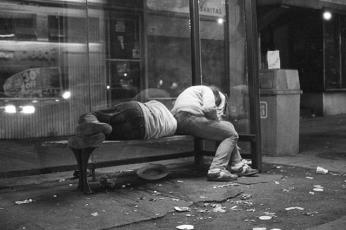 Homeless people sleeping at a bus stop, 14th and P St., NW, 1986. (Photo courtesy of Michael Horsley)