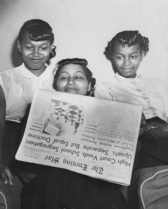 Barbara, Luberta, and Adrienne Jennings read the Evening Star on the day of the Supreme Court verdict. 