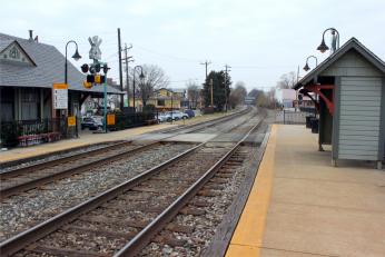 Modern view of Kensington Station with platform and railroad tracks