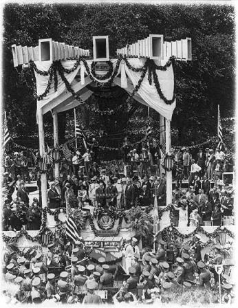 Charles Lindbergh on podium on Washington Monument grounds during his Washington, D.C., reception - Army band in foreground. (Source: Library of Congress)