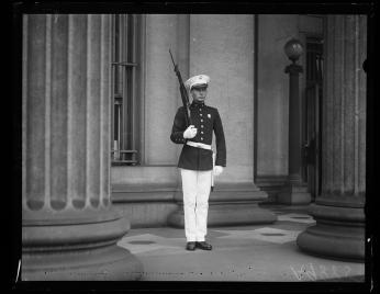 Marine guarding the U.S. Treasury during Ku Klux Klan march in Washington, August 8, 1925. (Source: Harris & Ewing Collection, Library of Congress)