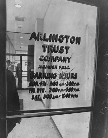 Bullet hole in the door of Arlington Trust Company bank in Crystal City, where the Tuller's crime spree began in 1972. (Reprinted with permission of DC Public Library, Star Collection © Washington Post)