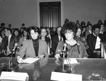 Congresswoman Nancy Pelosi and Elizabeth Taylor testifying before the House Budget Committee on HIV/AIDS Funding in early 1990. ( Courtesy of Nancy Pelosi.) Congresswoman Nancy Pelosi and Elizabeth Taylor testifying for HIV/AIDS Funding in 1990. (Photo source: Nancy Pelosi on Flickr)