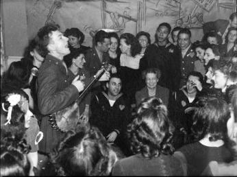 Pete Seeger performing at a party at the Congress of Industrial Organizations canteen in Washington DC in 1944, as First Lady Eleanor Roosevelt looks on. Credit: Library of Congress. Pete Seeger performing at a party at the Congress of Industrial Organizations canteen in Washington DC in 1944, as First Lady Eleanor Roosevelt looks on. Credit: Library of Congress.