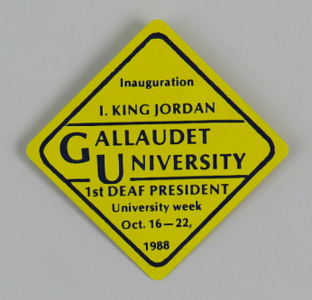 Image of a yellow diamond-shaped button commemorating the inauguration of I. King Jordan. Text on the button reads: Inauguration I. King Jordan, Gallaudet University, 1st Deaf President, University Week October 16-22 1988.