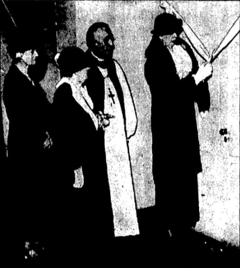 A grainy black-and-white newspaper photo. Eleanor Roosevelt, in a coat and hat, cuts a large ribbon across a door with a pair of scissors. Behind her, two women in coats and a bishop in bishop robes watch.