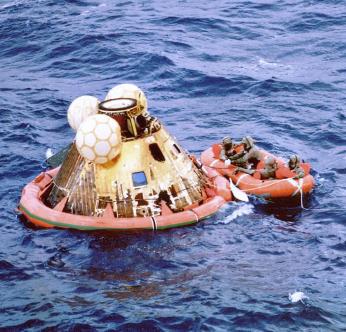 “Apollo 11 Crew and a Navy Diver Await Pickup from the USS Hornet after Splashdown.” 1969. <a href=