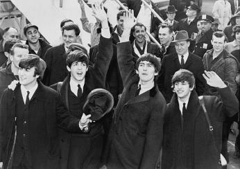 The Beatles were greeted by thousands of screaming teenagers when they arrived at Kennedy airport in New York on February 7, 1964. When they played their first American concert at the Washington Coliseum four days later, they were pelted with jellybeans while on stage. (Photo source: Wikipedia)