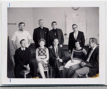 The Catonsville Nine after they got arrested after the action. Pictured are (l-r standing) George Mische, Philip Berrigan, Daniel Berrigan, Tom Lewis. (l-r seated) David Darst, Mary Moylan, John Hogan, Marjorie Melville, Tom Melville. (Source: Wikimedia Commons)