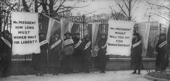 Women suffragists picketing in front of the White house on "College Day" in 1917. (Source: Wikipedia)