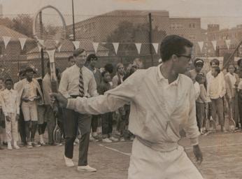 Arthur Ashe teaching children how to play tennis. Arthur Ashe teaching children how to play tennis.