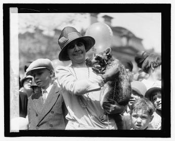 First Lady Grace Coolidge holds Rebecca the Raccoon