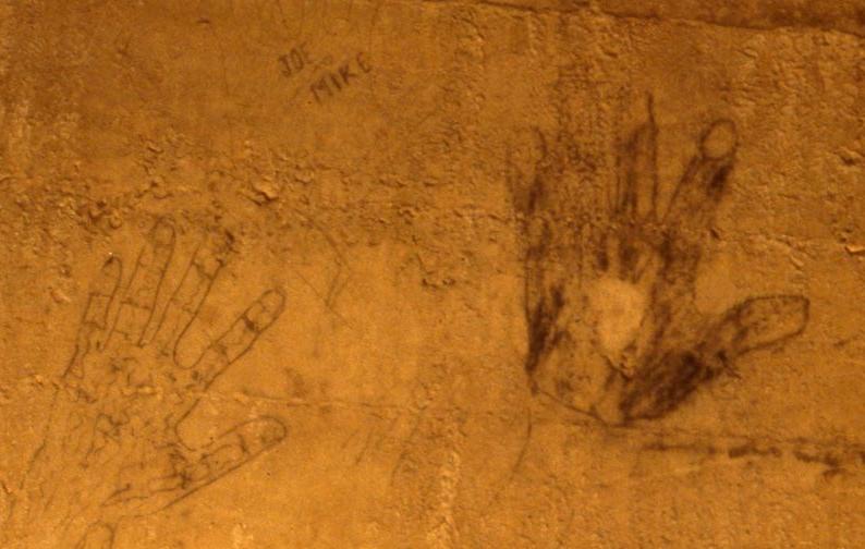 Two hand outlines drawn in charcoal, signed Joe and Mike