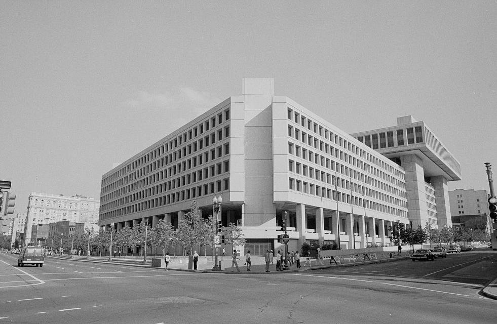 Black and white photo from 1977 of blocky concrete building in downtown D.C. intersection. 