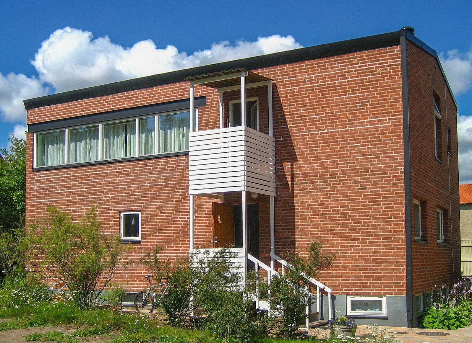 Photo of square brick villa.
