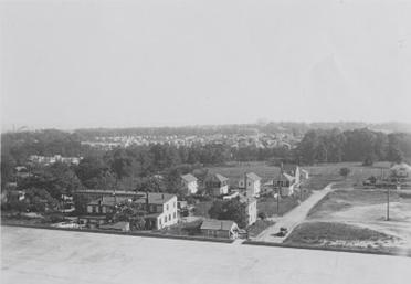 A black-and-white image with an aerial view of the Reno neighborhood, a few houses at the bottom of a hill.