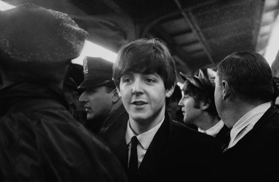 Paul McCartney and John Lennon are ushered through the crowd at Union Station on February 11, 1964. (Photo credit: Mike Mitchell)