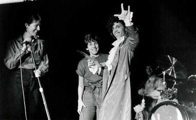Prince returns the "I Love You" sign while being presented with a gift by student representatives. (Photo: Courtesy of the Gallaudet University Archives)