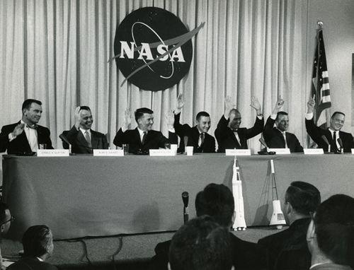 “The Mercury 7 astronauts (left to right) Slayton, Shepard, Schirra, Grissom, Glenn, Cooper, and Carpenter all raise their hands in reply to a question about whether they felt confident they would return from space – Glenn raised both hands,” 1959 (Photo Source: NASA) https://www.nasa.gov/feature/60-years-ago-nasa-introduces-mercury-7-astronauts