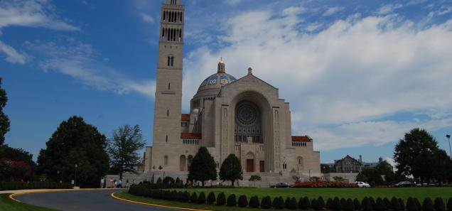 Basilica of the National Shrine of the Immaculate Conception against blue sky.